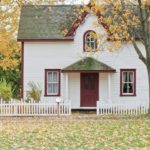 white-house-green-roof-white-picket-fence