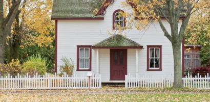 white-house-green-roof-white-picket-fence