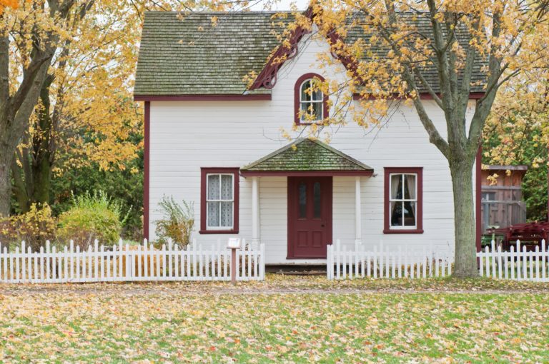 white-house-green-roof-white-picket-fence