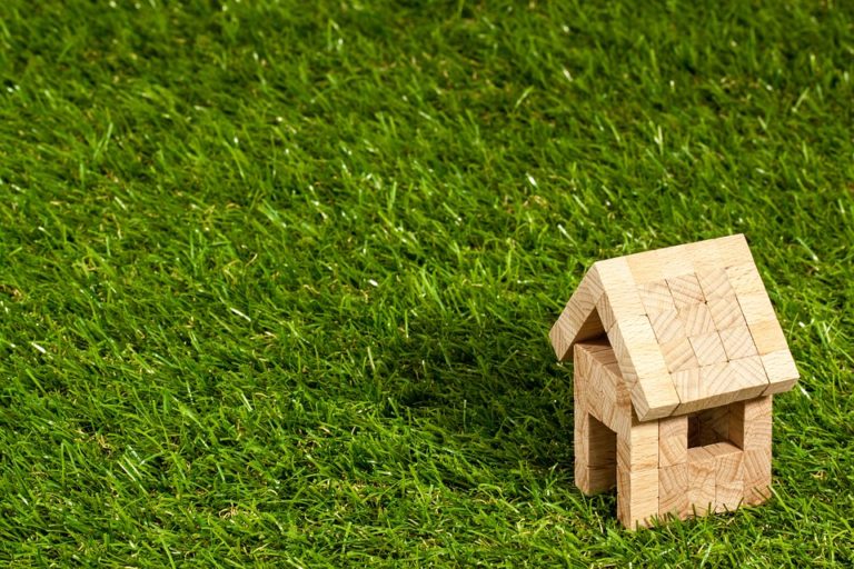 small wooden home on grass