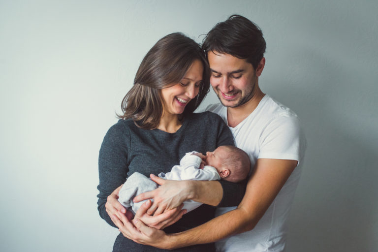 Woman and Man holding A Newborn baby