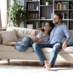 couple renters or tenants relax on couch in living room