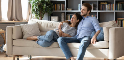 couple renters or tenants relax on couch in living room