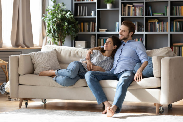 couple renters or tenants relax on couch in living room