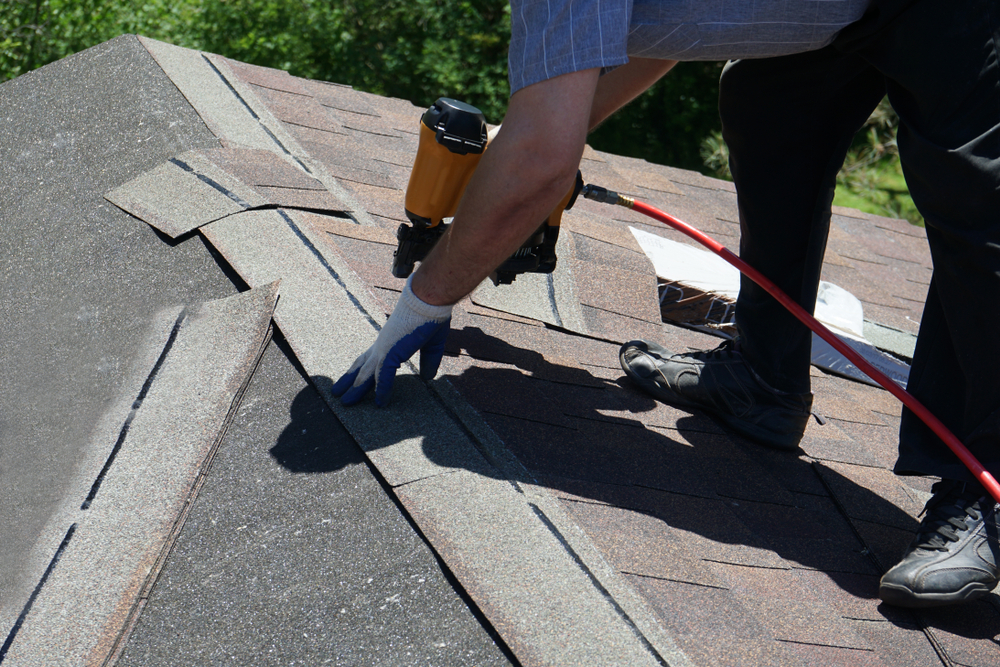 man replacing roof