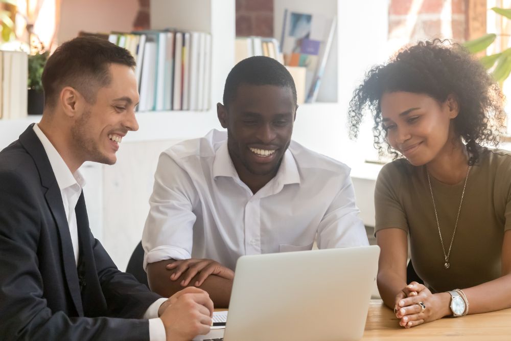 Insurance broker consulting couple showing online presentation on laptop