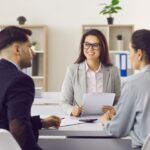 couple meets with insurance broker in office