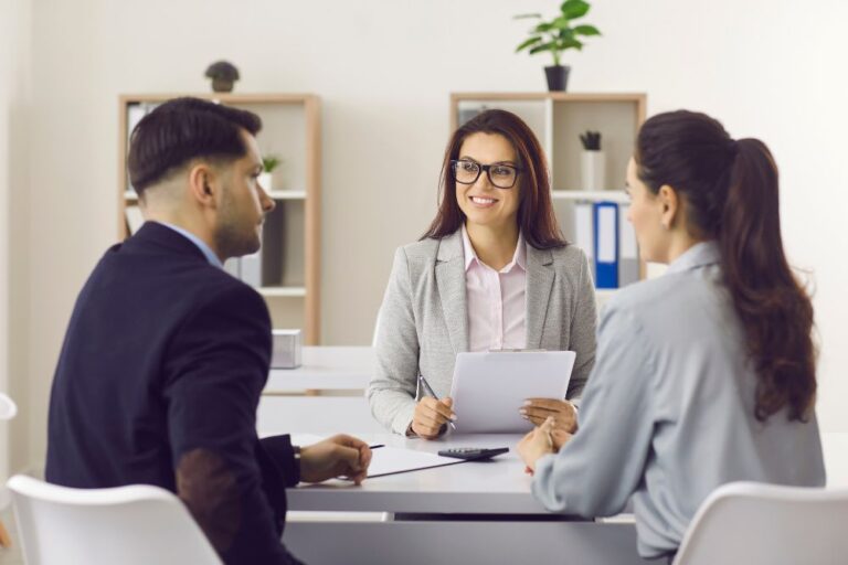 couple meets with insurance broker in office