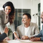 Business professionals smiling and collaborating during a meeting in an office