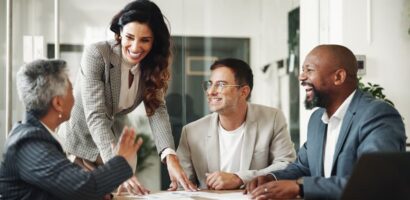 Business professionals smiling and collaborating during a meeting in an office