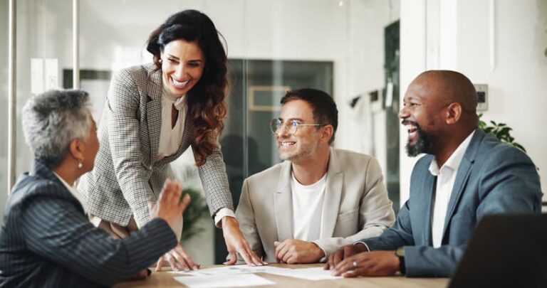 Business professionals smiling and collaborating during a meeting in an office