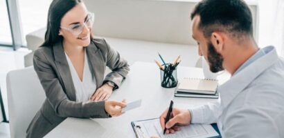 Client discusses coverage options with an insurance advisor while signing paperwork