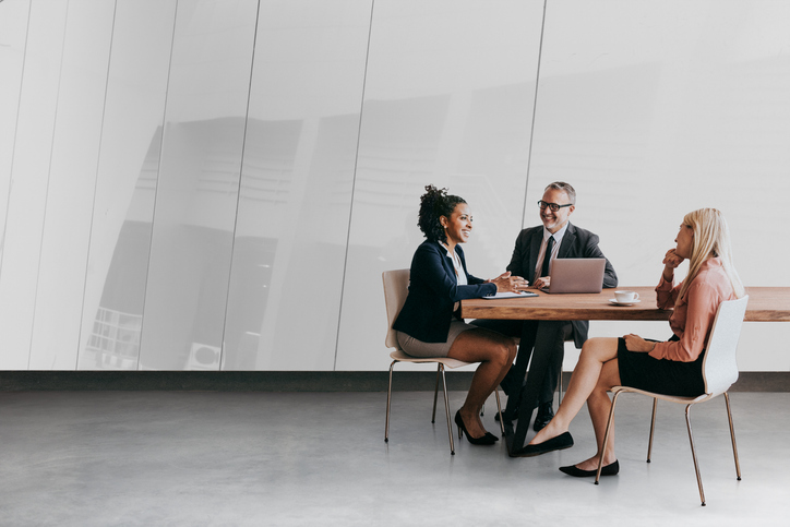 Business professionals meeting around a table in a modern office