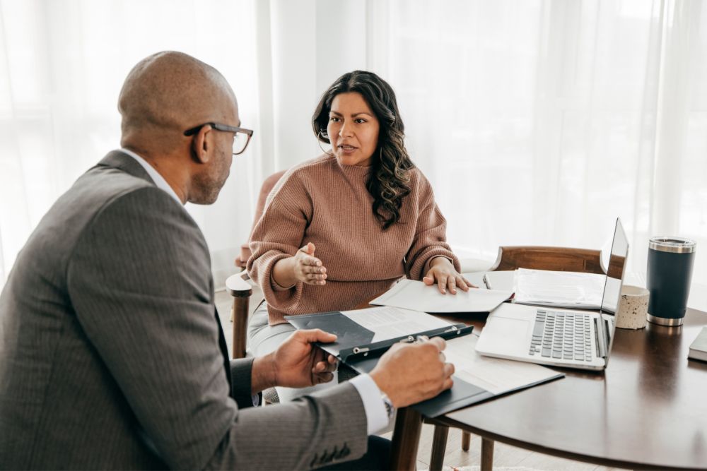 insurance agent and client discuss policy