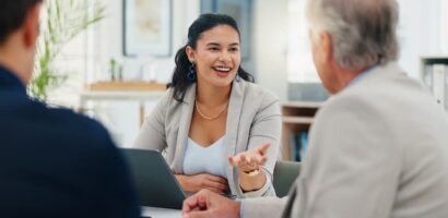 Insurance advisor speaking with clients during a business meeting