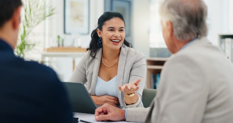 Insurance advisor speaking with clients during a business meeting